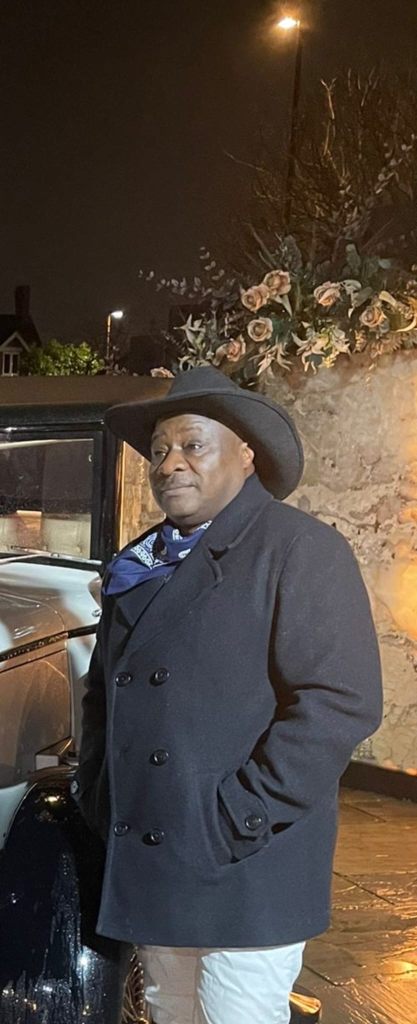 Ivo in a coat and hat in the evening